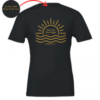 Load image into Gallery viewer, Black You Are The Light shirt, flat front view: a half sun rising over water with You Are The Light in serif inside the sun, and Matthew 5:14 below.

